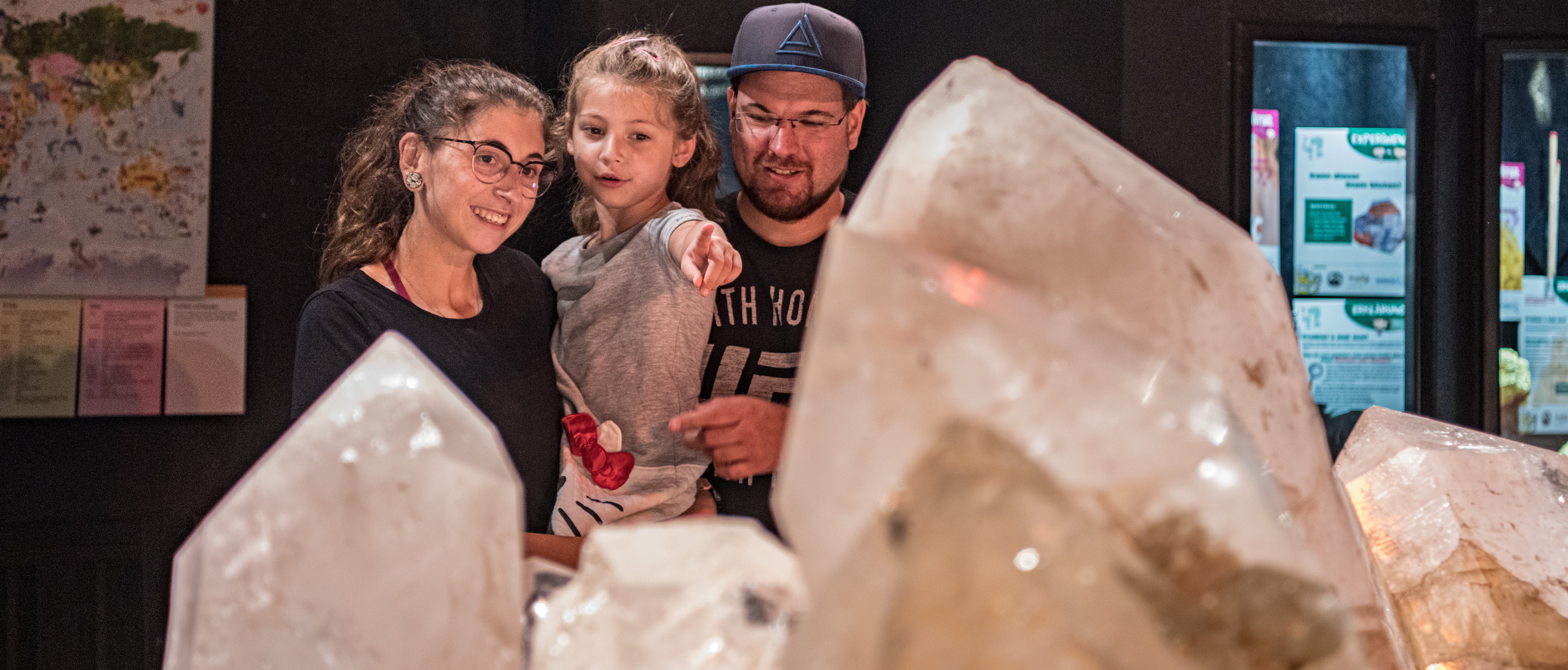 Auf diesem Foto sieht man eine Familie im Kristallmuseum den Bergkristall bestaunen